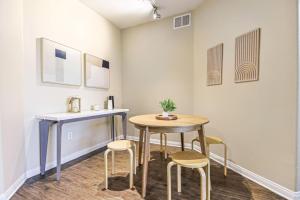 a table and stools in a room with a table and chairs at Spacious 2BDR Condo near Venice Beach in Los Angeles