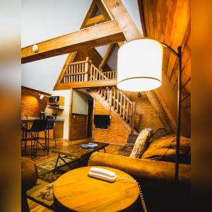 a living room with a couch and a table at A-Frame #01 - by The Chalets in Logan