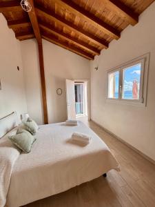 a bedroom with a large bed and a window at BRES House in Porto Santo Stefano