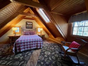 a bedroom with a large bed in a attic at Alpine - by The Chalets in Logan