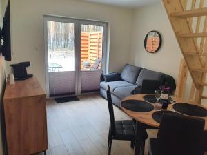 a living room with a couch and a table at Apartament Sielpia DeLuxe 2 in Sielpia Wielka