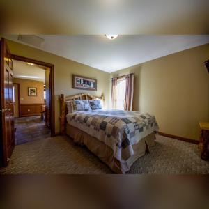a bedroom with a large bed in a room at Coyote - by The Chalets in Logan