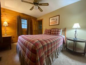 a bedroom with a bed and a ceiling fan at Cumberland - by The Chalets in Logan