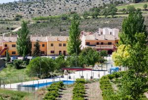 a view of a resort with a swimming pool at CASERIO INAZARES - MONTAÑA, CHIMENEA, NIEVE, BARBACOa in Moratalla