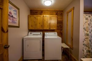 a small kitchen with a washer and dryer at Dogwood - by The Chalets in Logan +37 photos