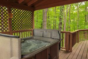 a hot tub on the deck of a gazebo at Elk - by The Chalets in South Bloomingville
