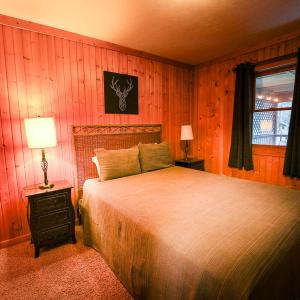 a bedroom with a large bed and a window at Falls - by The Chalets in Logan