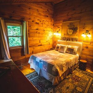 a bedroom with a bed in a log cabin at Hemlock - by The Chalets in Logan +16 photos