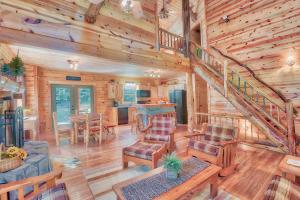 a living room with a staircase in a log cabin at Hidden Heights - by The Chalets in South Bloomingville