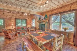 a dining room with a wooden table in a cabin at Hidden Heights - by The Chalets in South Bloomingville