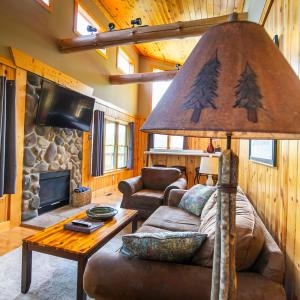 a living room with a couch and a table at Overlook - by The Chalets in Logan