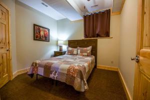 a bedroom with a bed and a window at Overlook - by The Chalets in Logan