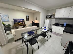 a kitchen and living room with a table and chairs at Apartamento no centro de São Lourenço e a 750 metros do parque in São Lourenço