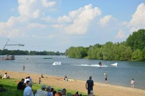 a group of people on a beach near a lake at Accomondation Unterkunft Dreizimmerwohnung in Salzgitter