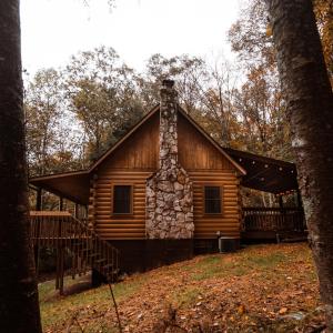a log cabin in the middle of the woods at Pioneer - by The Chalets in South Bloomingville