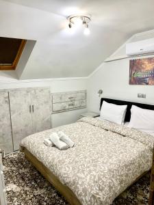 a bedroom with a bed with two towels on it at Coastal vista retreat in Neos Panteleimonas