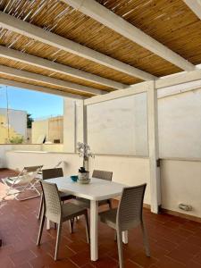 a white table and chairs on a patio at Favignana in centro con terrazza in Favignana