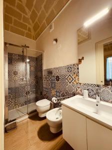 a bathroom with a sink and a toilet and a shower at Favignana in centro con terrazza in Favignana +34 photos