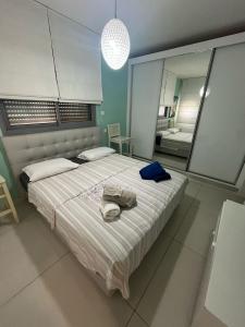 a bedroom with a large bed with a hat on it at רויאל פארק פרימיום in Eilat