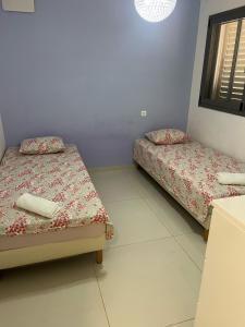 a room with two beds and a window at רויאל פארק פרימיום in Eilat +2 photos