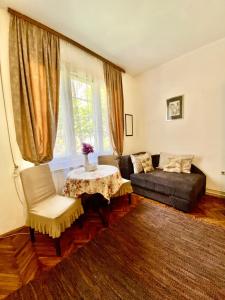 a living room with a couch and a table at Apartment Rustico Belgrade in Belgrade