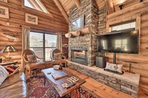 a living room with a fireplace and a tv at Trout Lodge at Two Rivers-White River Cabin in Norfork