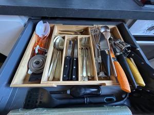 a drawer full of kitchen utensils in a container at Home Lyla in Dijon +29 photos