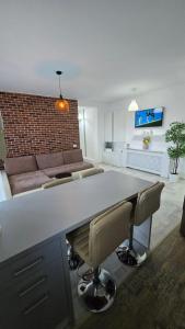a living room with a large table and a couch at Happy Architect in Cisnădie