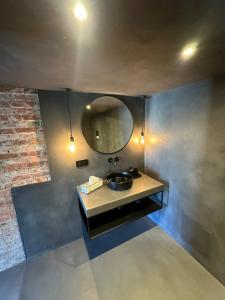a bathroom with a sink and a mirror at Le Garage de Charly Piscine, Sauna & Gym - Aux rêves des Champs in Éghezée +16 photos