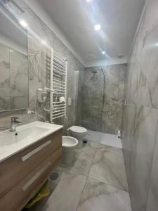 a bathroom with a sink and a toilet and a shower at Vitiello Maria's home in Pompei +22 photos