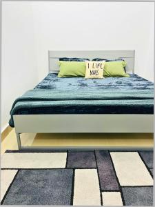 a bedroom with a bed with a blue comforter at Shankar Bhawan Rishikesh - Heritage AC Stay near Triveni Ghat & ISBT in Rishīkesh