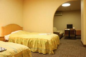 Giường trong phòng chung tại Nasushiobara Station Hotel
