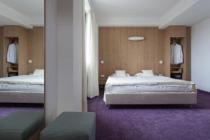 Säng eller sängar i ett rum på City Park Hotel