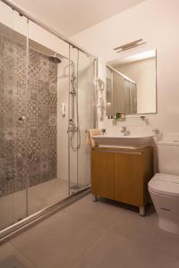 a bathroom with a sink and a shower and a toilet at City Park Hotel in Skopje