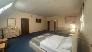 a bedroom with a large bed and a dresser at Sava Dream СПА-мотель in Zhytomyr