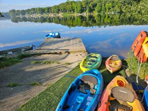 a group of kayaks on the shore of a lake at Castaways Cottage on Croton Pond #5 in Newaygo