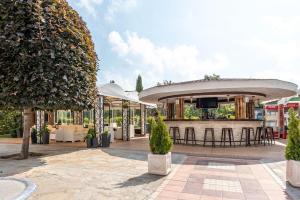 a patio with a bar with a tv on it at Hermann's Sea View Apartment - Bendita Mare in Varna City