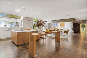 a kitchen with a wooden table and a dining room at luxury 4 bedroom villa in Benalmádena