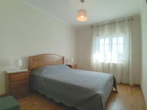 a bedroom with a bed and a window at Casa D'Araújo in Arcos de Valdevez