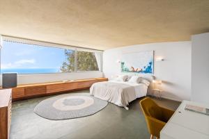 a bedroom with a bed and a large window at luxury 4 bedroom villa in Benalmádena +27 photos