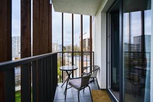 Un balcón con mesa y sillas y vista a una ciudad. en Full-Equipped 1BR in Center by Torro Mall, en Chişinău