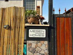 a sign that says meen homes on a fence at Milas-Bodrum Özel Havuzlu Triplex Villa in Milas
