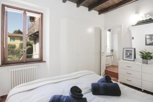 a bedroom with a bed with two towels on it at In the Historic Village - Riva Lago 10 in Carate Urio