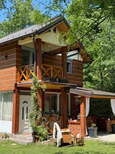 a brick house with a porch and a patio at Drinski kej in Zvornik