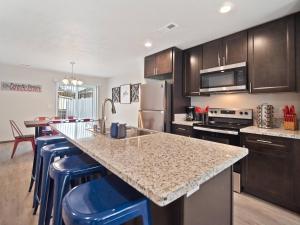 a kitchen with a large island with blue bar stools at 1mile To Arenagonzagaetc Wd, Off St Parking in Spokane