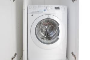 a white washing machine with its door open at In the Historic Village - Riva Lago 10 in Carate Urio