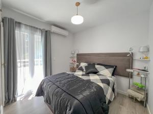a bedroom with a bed and a large window at Relaxing Family Retreat with Stunning Golf Views in Benalmádena +32 photos