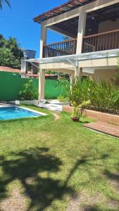 a house with a swimming pool in a yard at Caminho do Paraíso in Porto De Galinhas