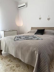 a bedroom with a large bed with a black pillow at Villa Annunziata Luxe in Aragona
