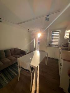 a living room with a white table and a couch at YourHome 1 in Haigerloch